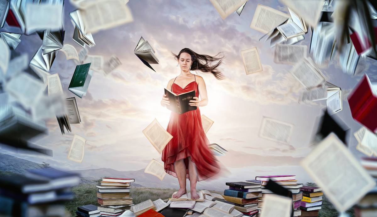 Woman in a red dress reading a book.