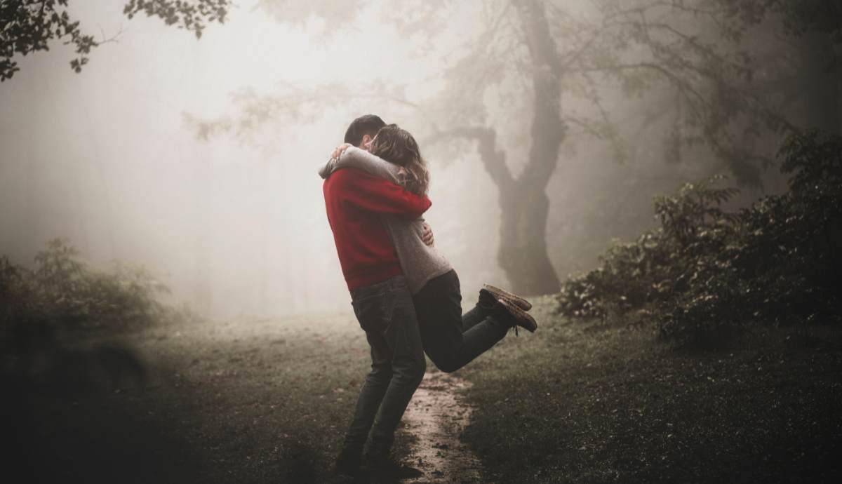 couple hugging in the wilderness