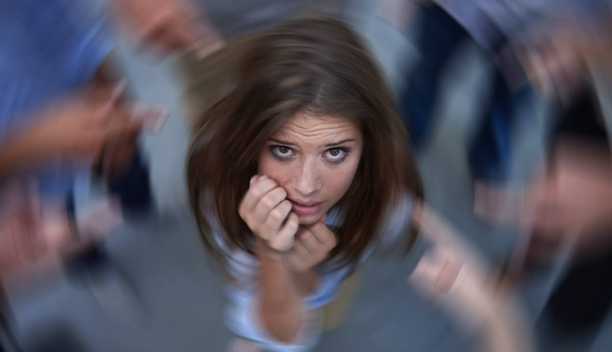 woman surrounded by pointing fingers